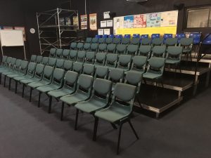 Tiered seating staging systems with chair