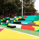 Vibrant and Eye-catching Tiered Seating with Custom finishes for Netball Australia by Select Staging Concepts